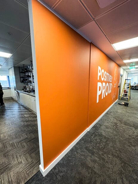 An image of the "Positively Proud" wall graphic.
